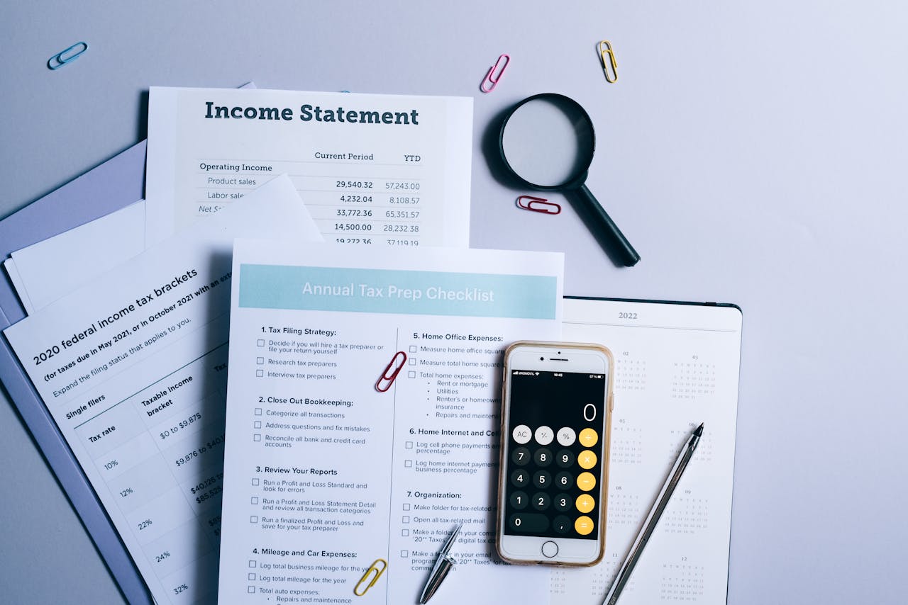 cta-bg An organized desk with tax documents, checklist, and gadgets for tax preparation.