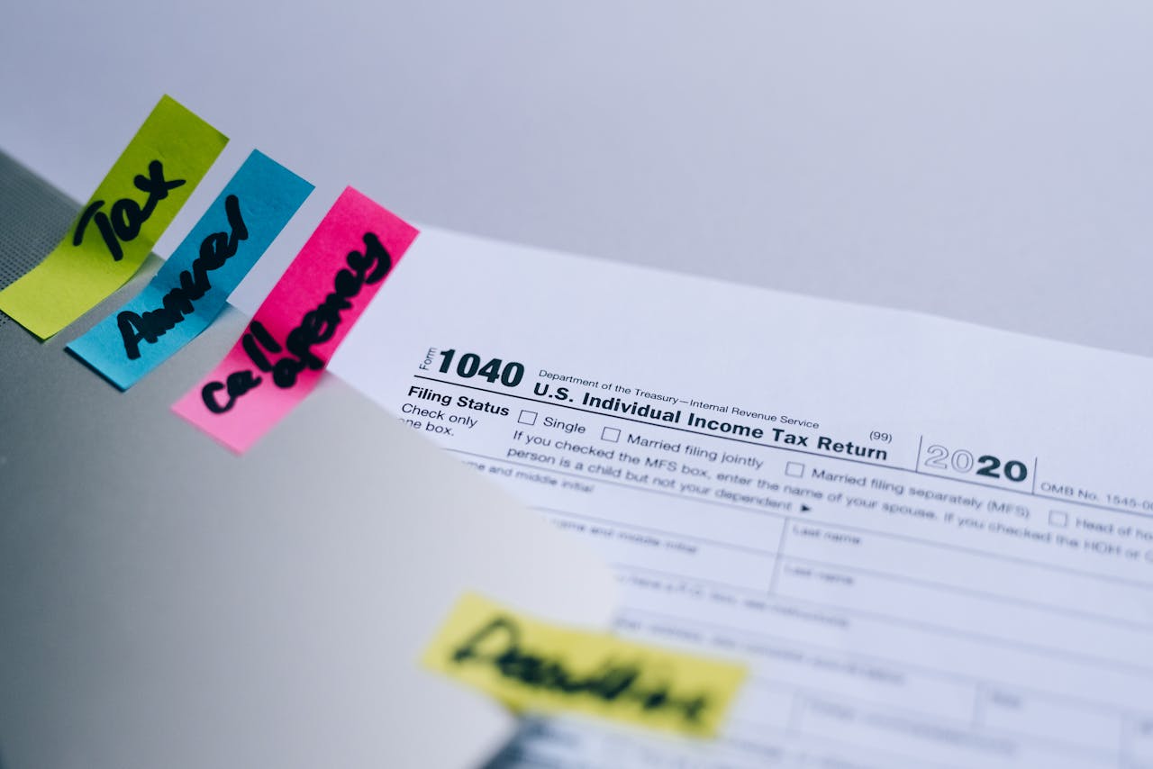 testimonials-img Close-up of 1040 U.S. tax form with colorful sticky notes for organization.