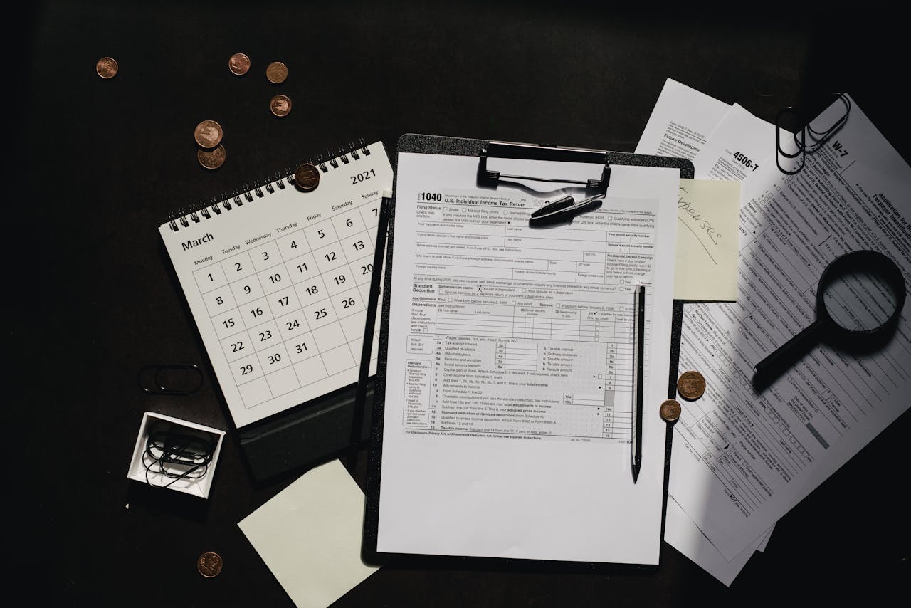 home-hero-bg A neatly organized workspace featuring tax forms, calendar, magnifying glass, and office supplies for efficient tax preparation.