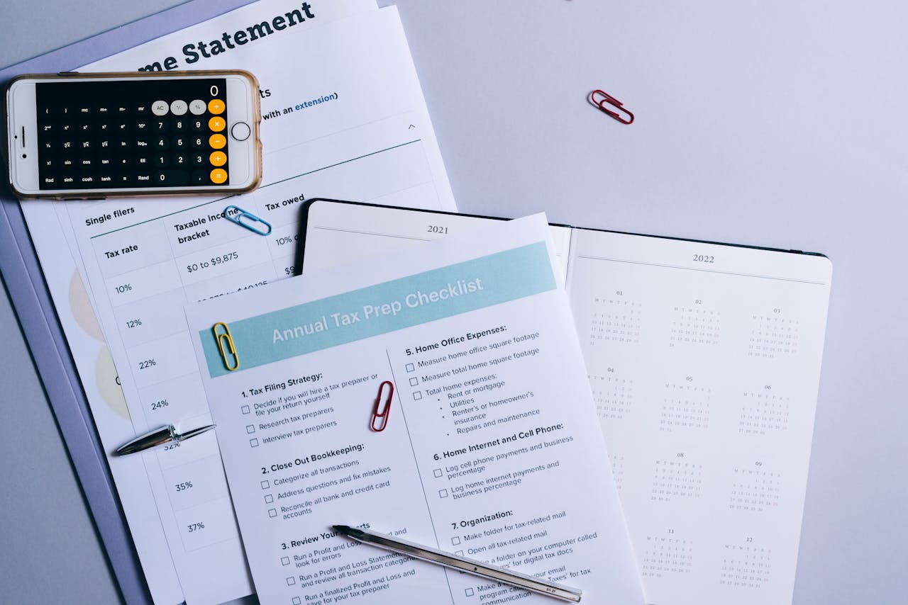 home-services-01 Flat lay of a tax preparation checklist, calculator, and financial documents on a desk.